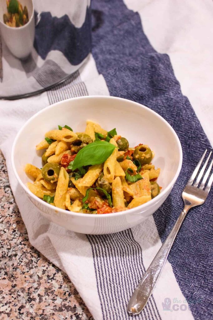 baked feta pasta with tomatoes, olives, and basil