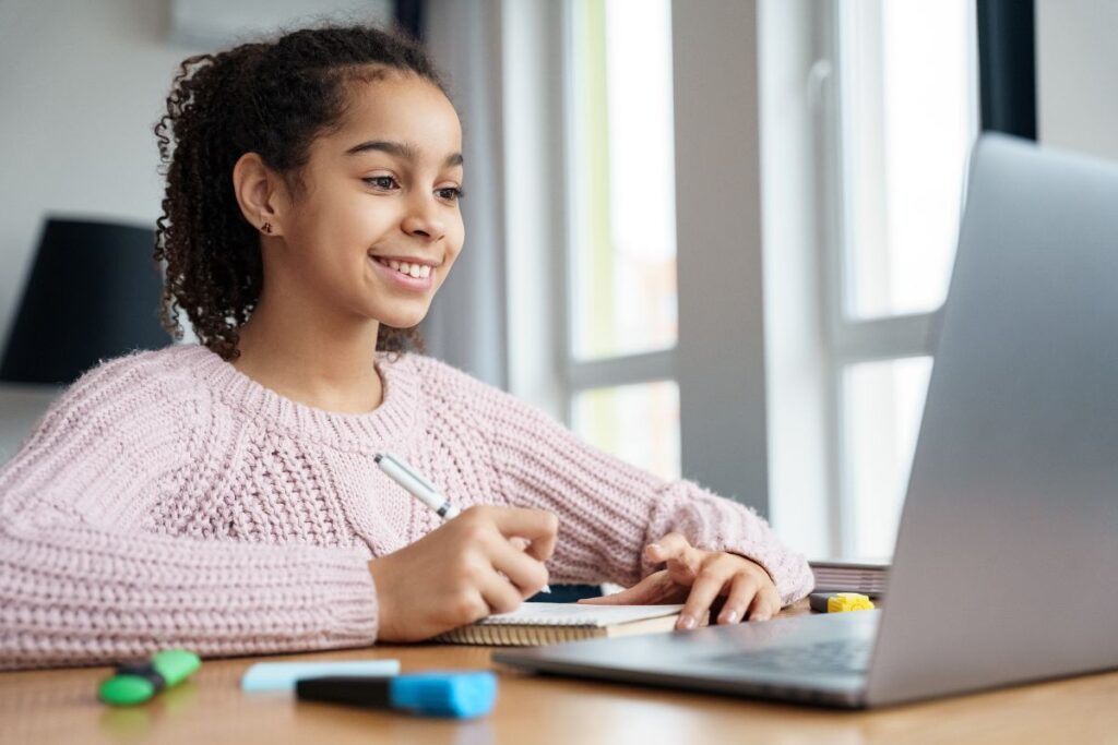 a teen girl working on a computer