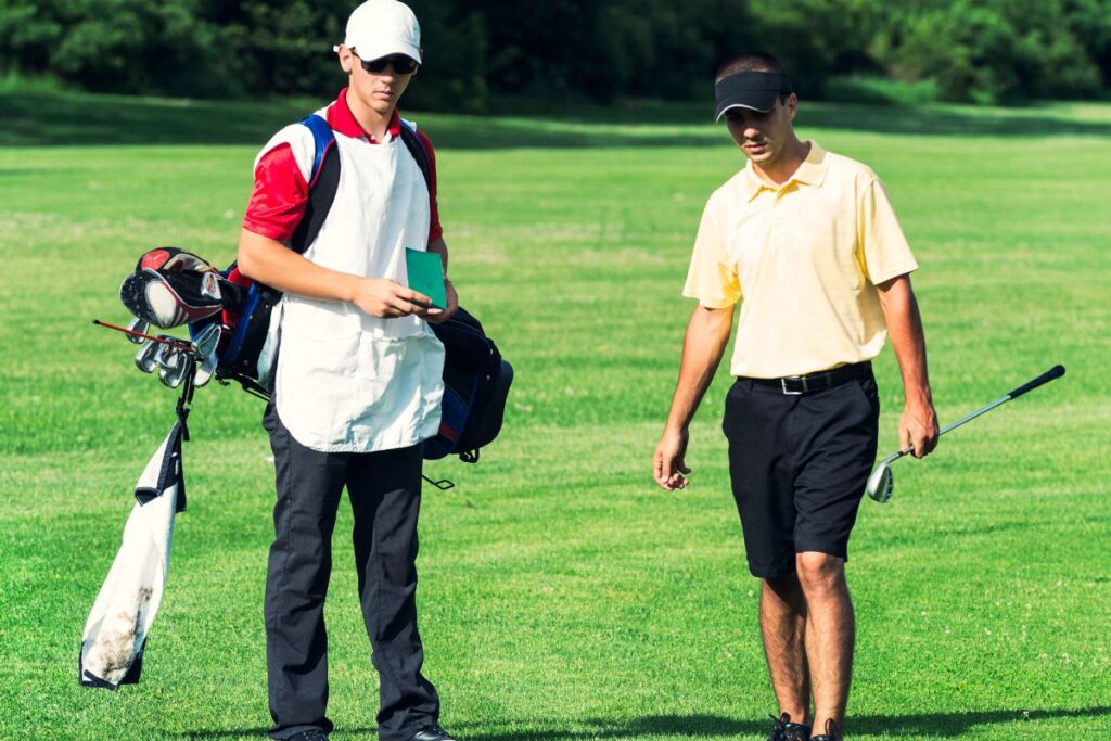 a teen boy working as a golf caddy