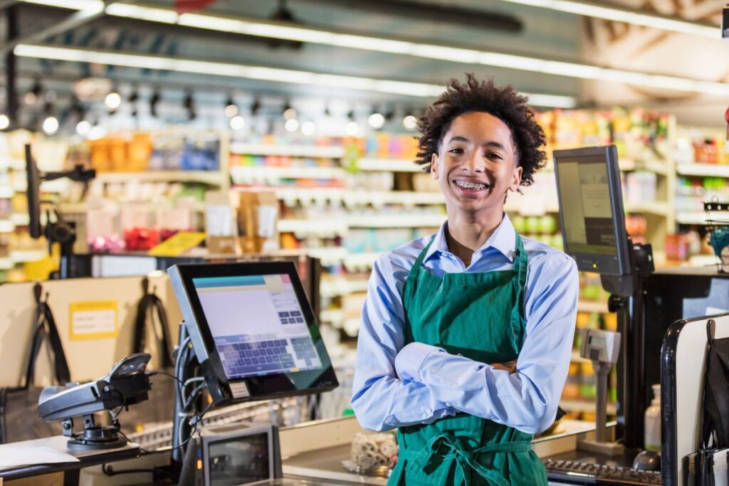 a teenage boy working at the grocery store